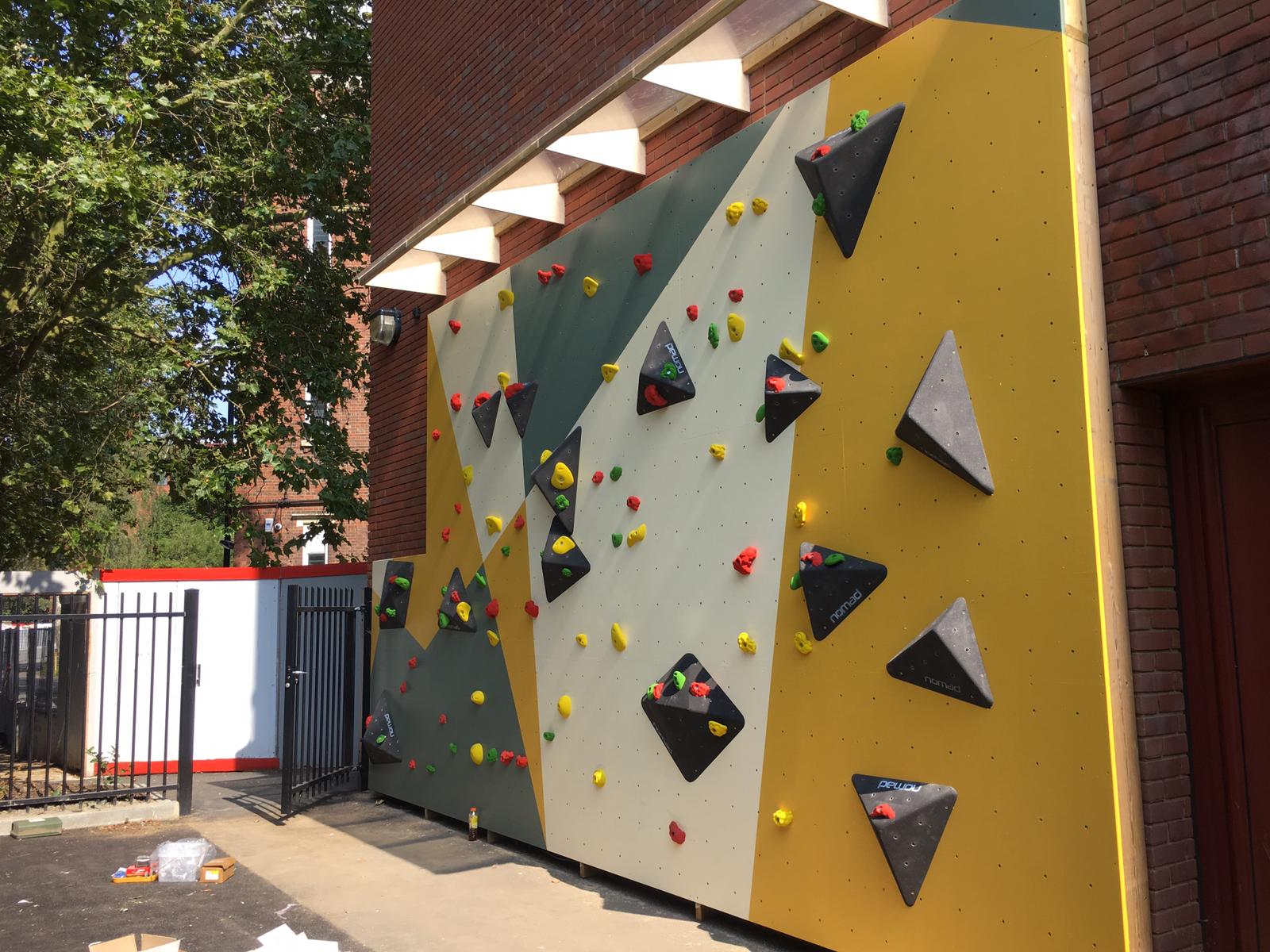 Traverse climbing wall in Dulwich, London, England with colourful climbing holds