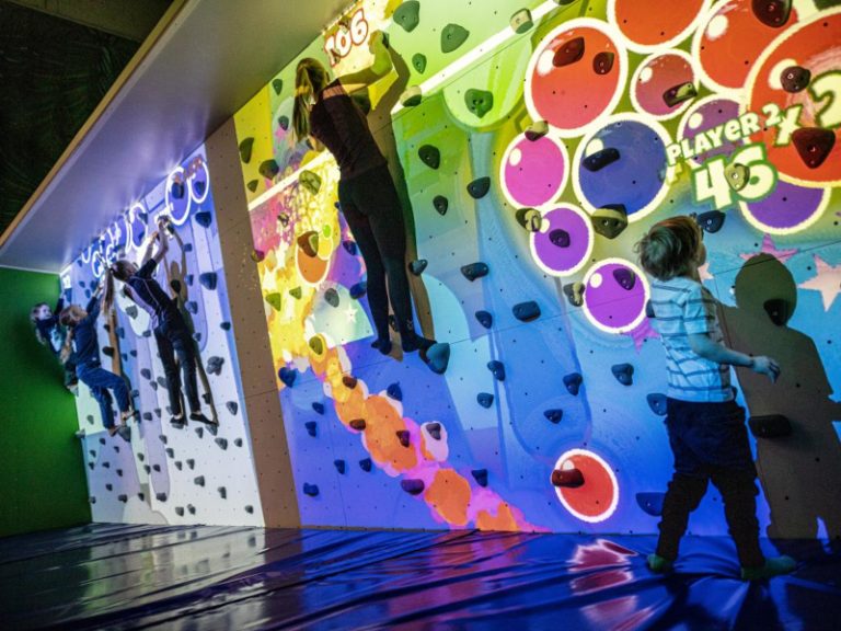 Home 10 Kids playing on Valo Motion ValoClimb interactive climbing wall with Hullaballoon game at birthday party event