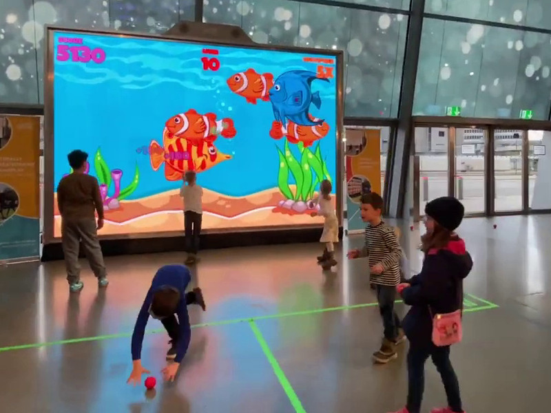 Home 8 Kids play undersea game at corporate event with MultiBall exergaming multi-sports gaming wall