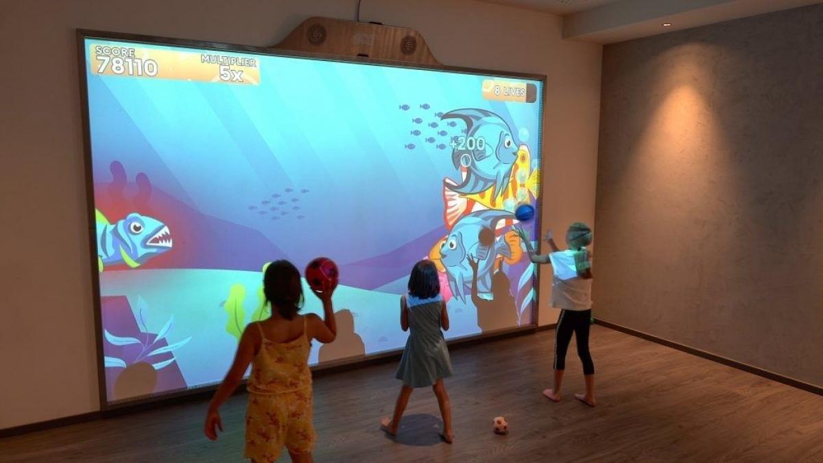 MultiBall 5 Young girls play undersea themed game on MultiBall multi-sports gaming wall for interactive sports and leisure