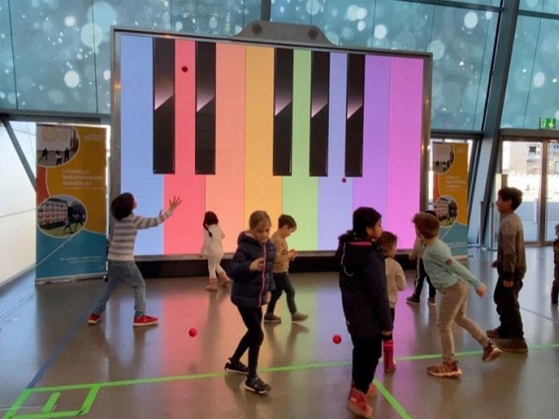 Event Hire 7 Kids play ball game with music theme on MultiBall exergame with multi-sports gaming wall for interactive sports and leisure