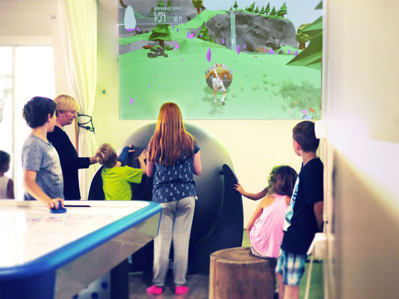 FoxBall (SisyFox) 7 Woman helps young boy exergaming with FoxBall aka SisyFox Physical Gaming platform for interactive fitness