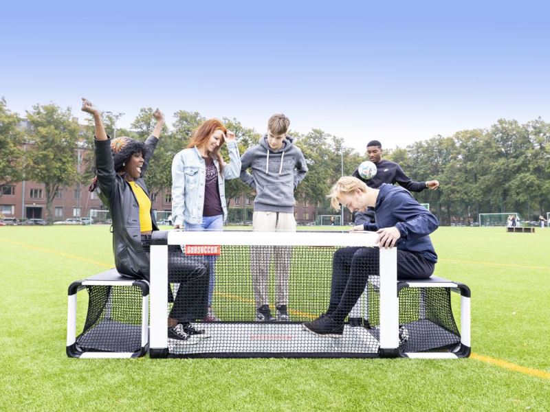 Subsoccer® 4 Joyful female scores goal while playing Subsoccer® table football game in park