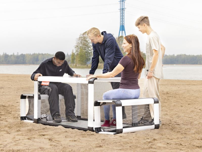 Subsoccer® 7 Young male and female compete on beach with Subsoccer® table football game for interactive sports and leisure