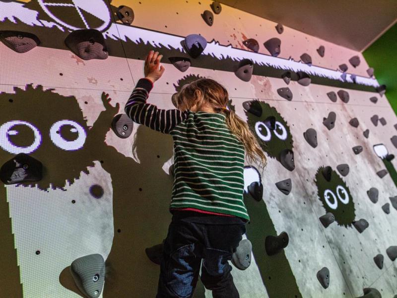 ValoClimb 9 Young girl has fun on Valo Motion ValoClimb interactive climbing wall with Shadowlings game