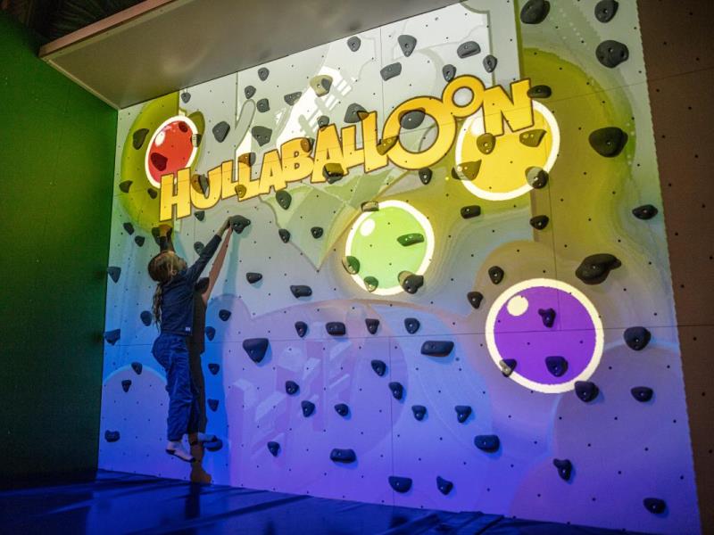 ValoClimb 4 Young girl plays on Valo Motion ValoClimb interactive climbing wall with Hullaballoon game
