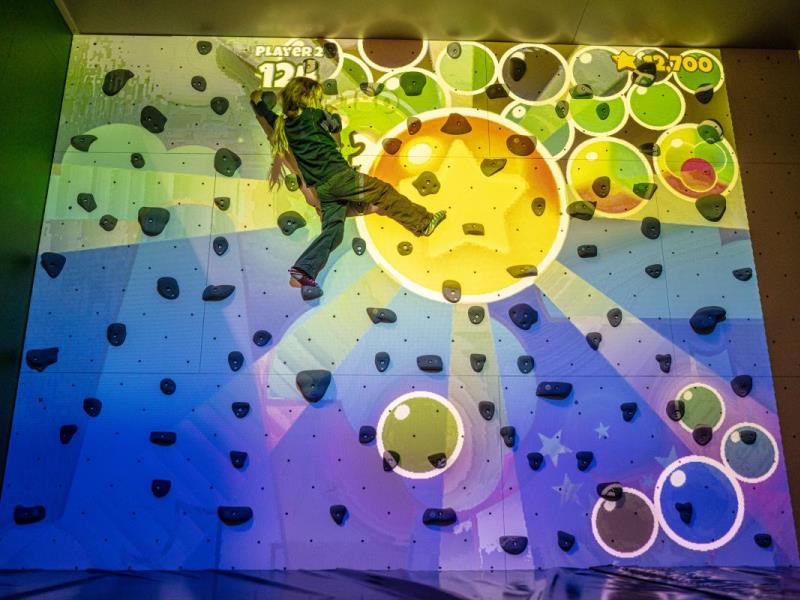 ValoClimb 3 Young girl climber Valo Motion ValoClimb immersive climbing wall with Hullaballoon for interactive sports and leisure