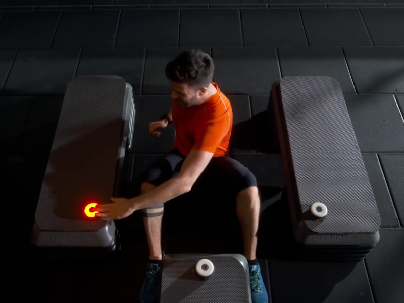 BlazePod 7 Young male doing fitness routine with BlazePod LED Reflex Training Lights.