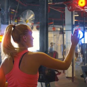 Event Hire 15 Young woman in front of mirror with active BlazePod LED Reflex Training Lights.