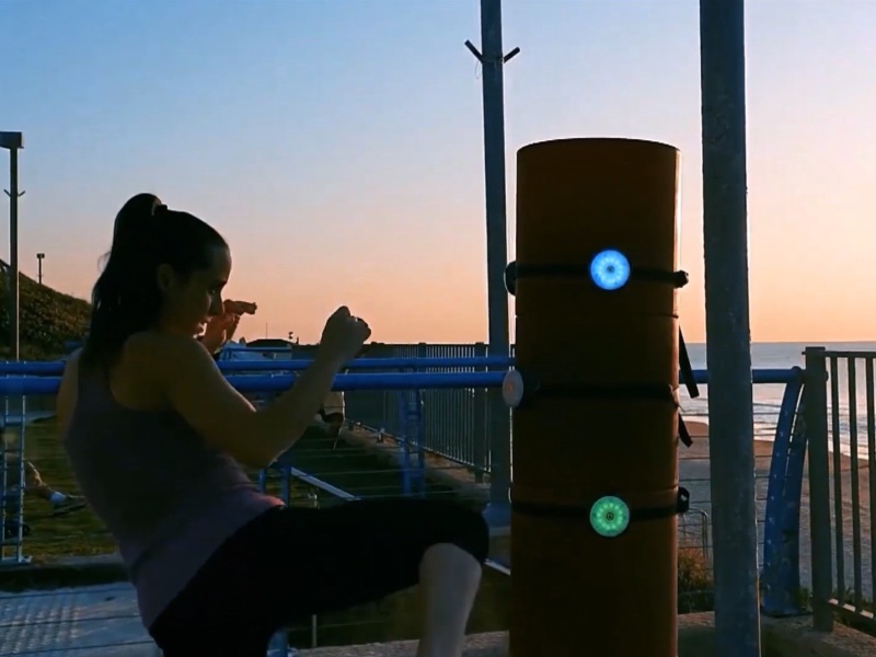 BlazePod 5 Young female trains with interactive BlazePod Flash Reflex Training Lights.