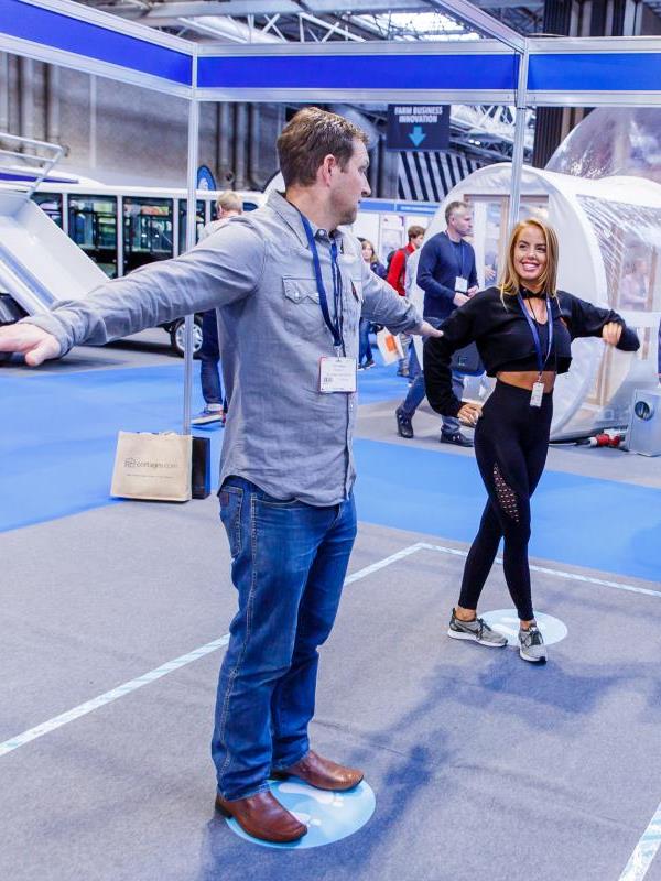 Home 2 Male and young female at exhibition exergaming with CSE iWall for Interactive Sports and leisure