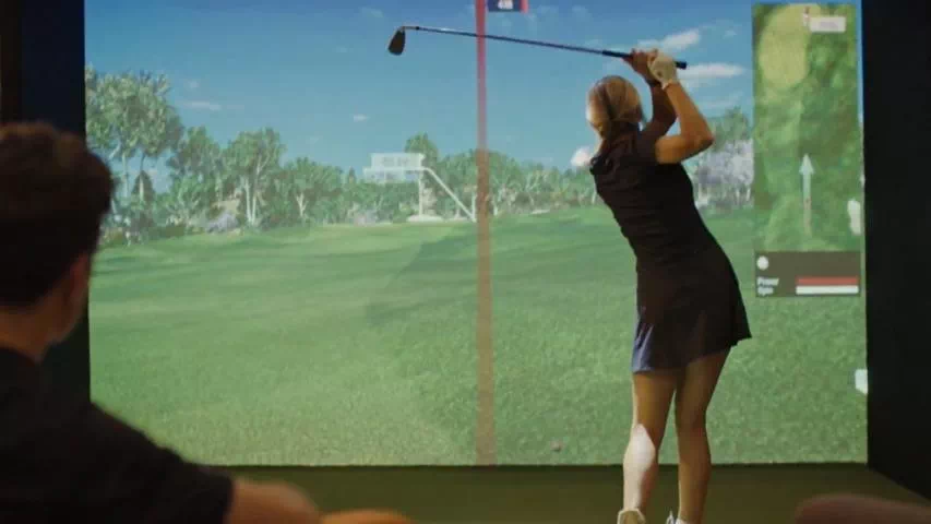 golfin idra golf simulator launch monitor hire young female plays golf